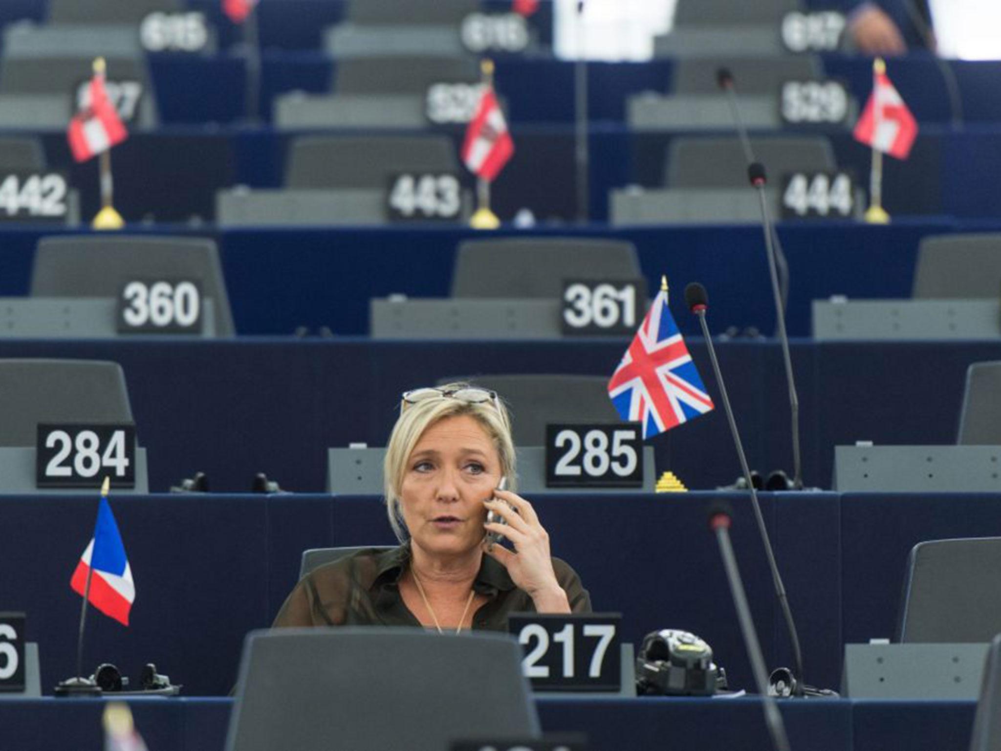 Marine Le Pen speaks on her mobile phone as she prepares for the annual State of The European Union speech
