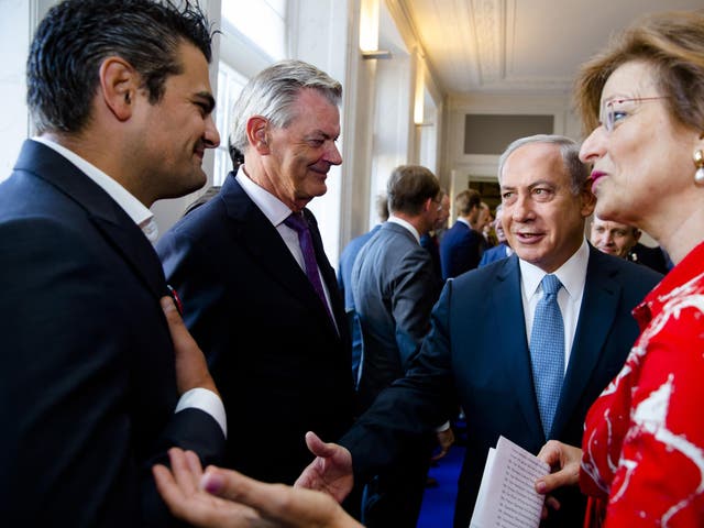 Dutch Parliament Member Tunahan Kuzu (L) refuses to shake hands with Prime Minister Benjamin Netanyahu during his visit to the States General at the Binnenhof as part of Netanyahu's visit to the Netherlands at the Binnenhof, in the Hague