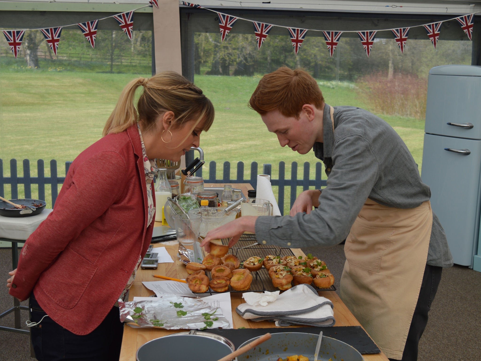 Mel looks on as Andrew puts the finishing touches to his Spanish-inspired filled Yorkshire puddings in the signature challenge