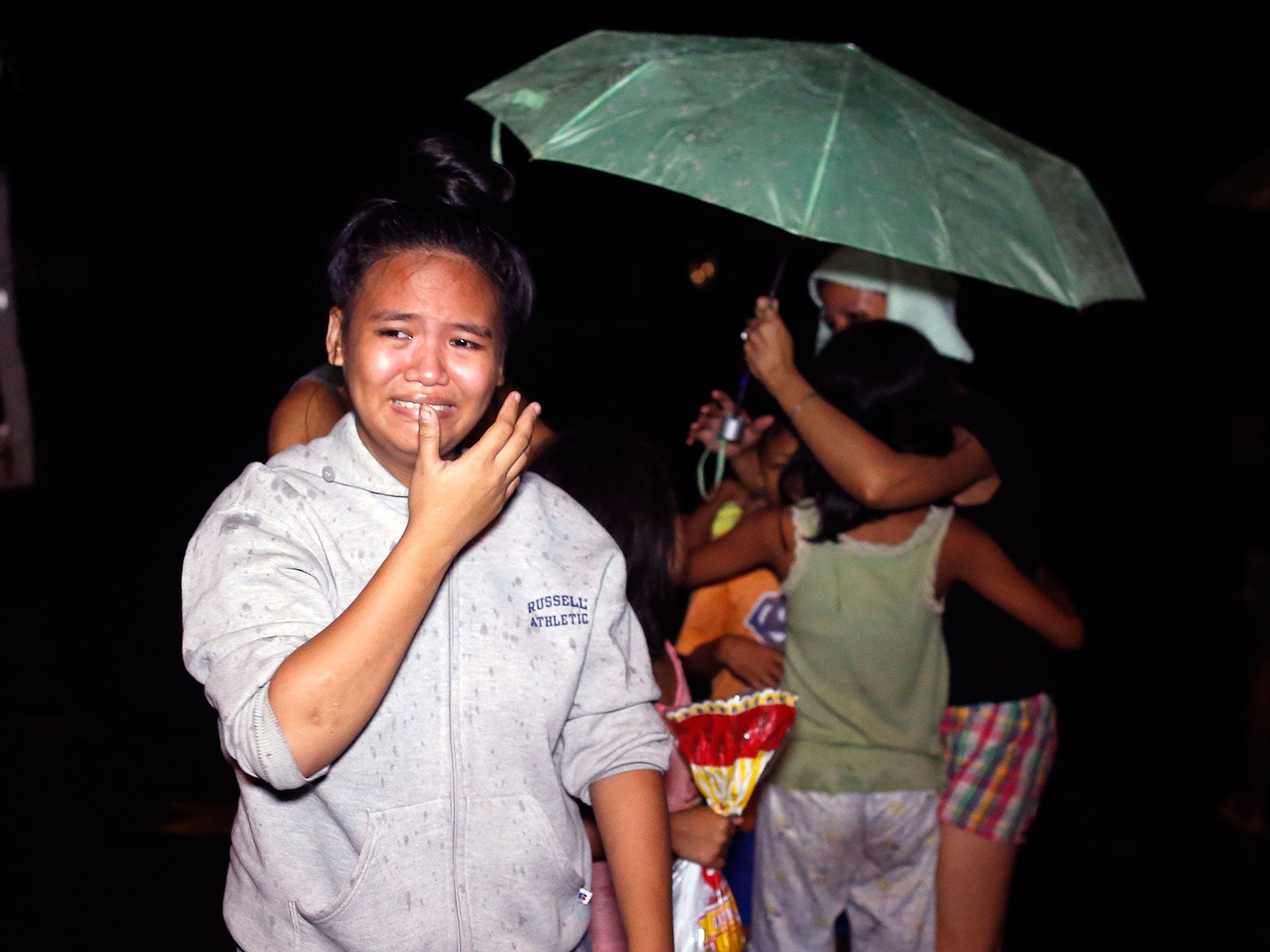 Relatives of an alleged drug dealer who was killed during a police operation against illegal drugs, mourning at the site of a police operation in Manila, on 9 September