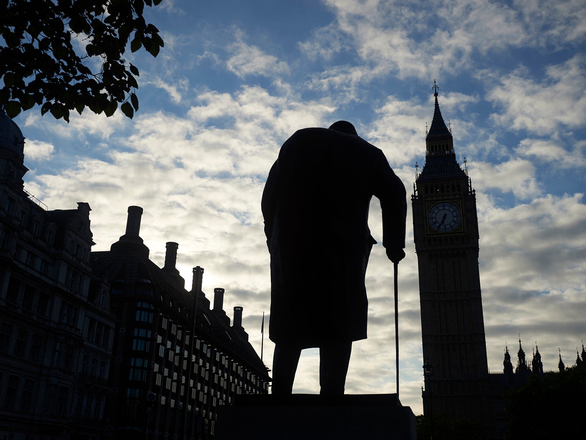 A bronze statue of Churchill looks out over Big Ben in London