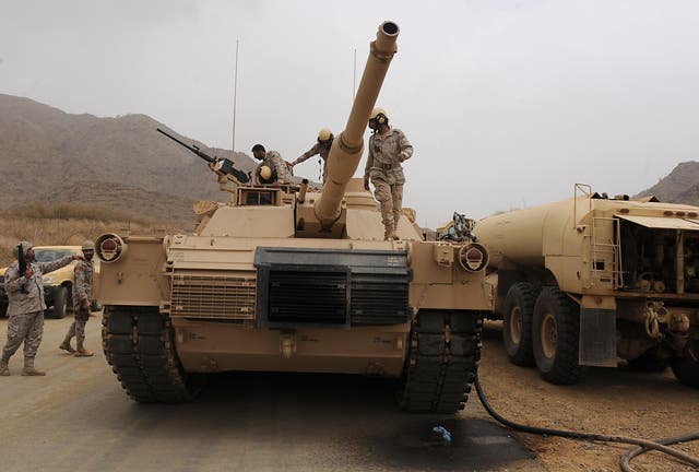 Saudi soldiers are seen on top of a tank deployed at the Saudi-Yemeni border on 13 April, 2015