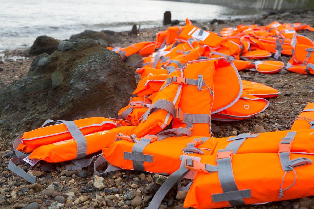 Life jackets on a beach for an art installation representing the thousands who have died during the refugee crisis