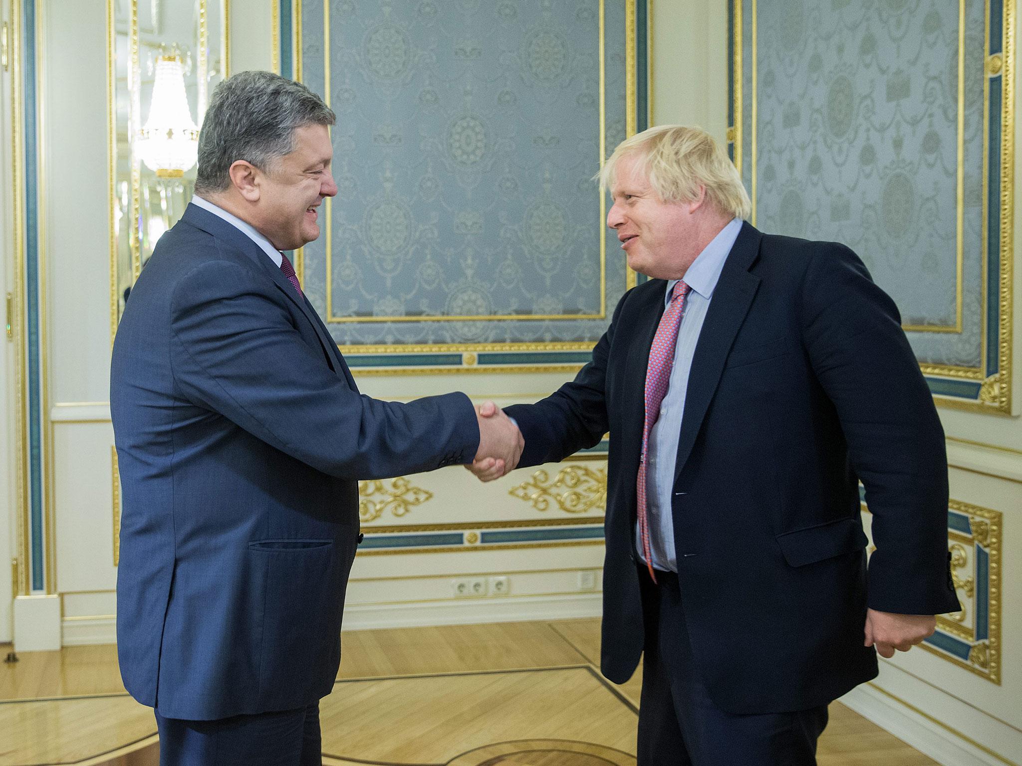 Ukrainian President Petro Poroshenko (left) greets Boris Johnson during their meeting in Kiev
