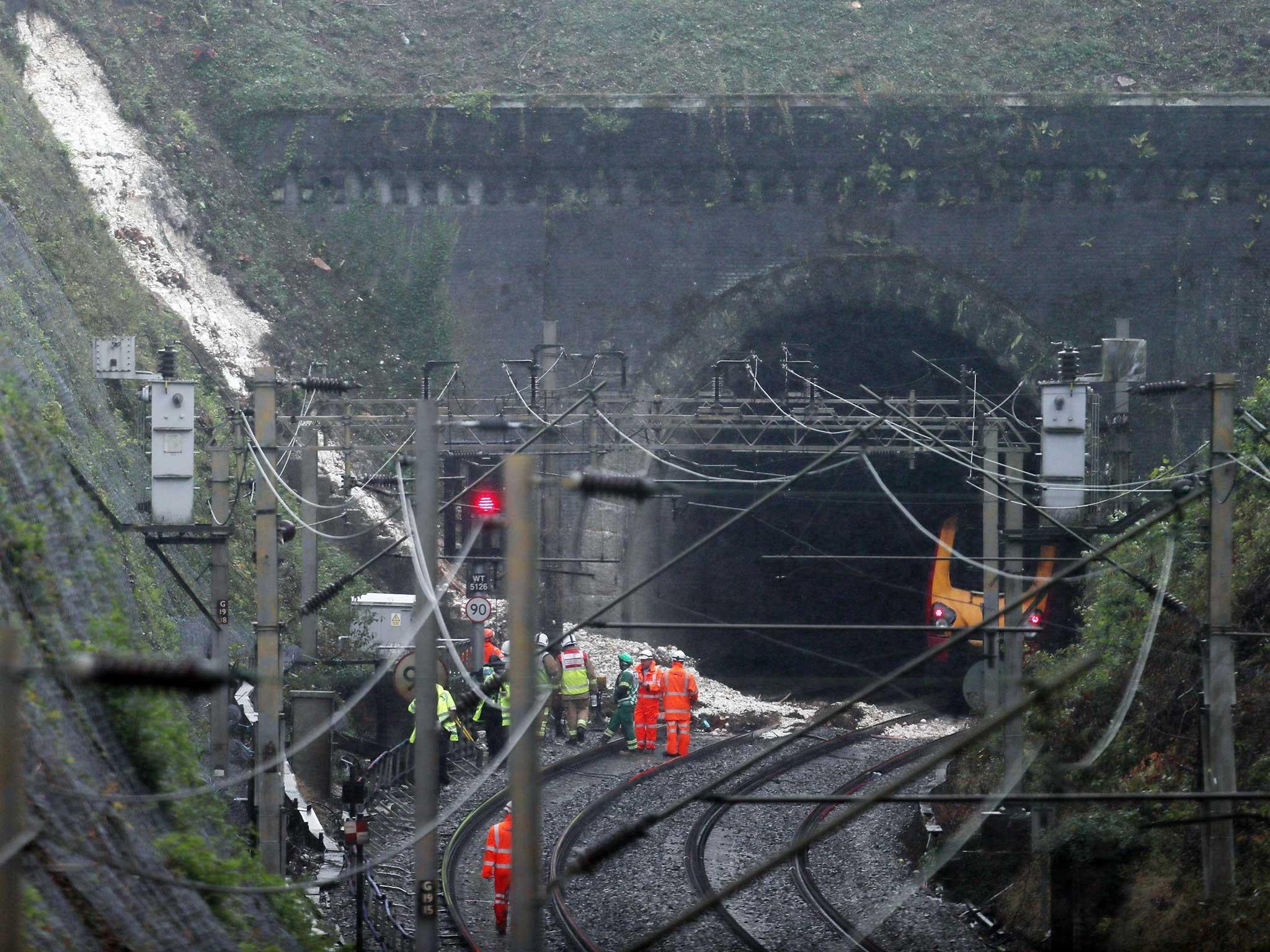 Workers at the landslide near Watford Junction station which has caused a train to be derailed