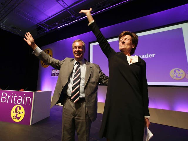 Outgoinng leader Nigel Farage looks on as he instroduces new leader of the anti-EU UK Independence Party (UKIP) Diane James at the UKIP Autumn Conference in Bournemouth