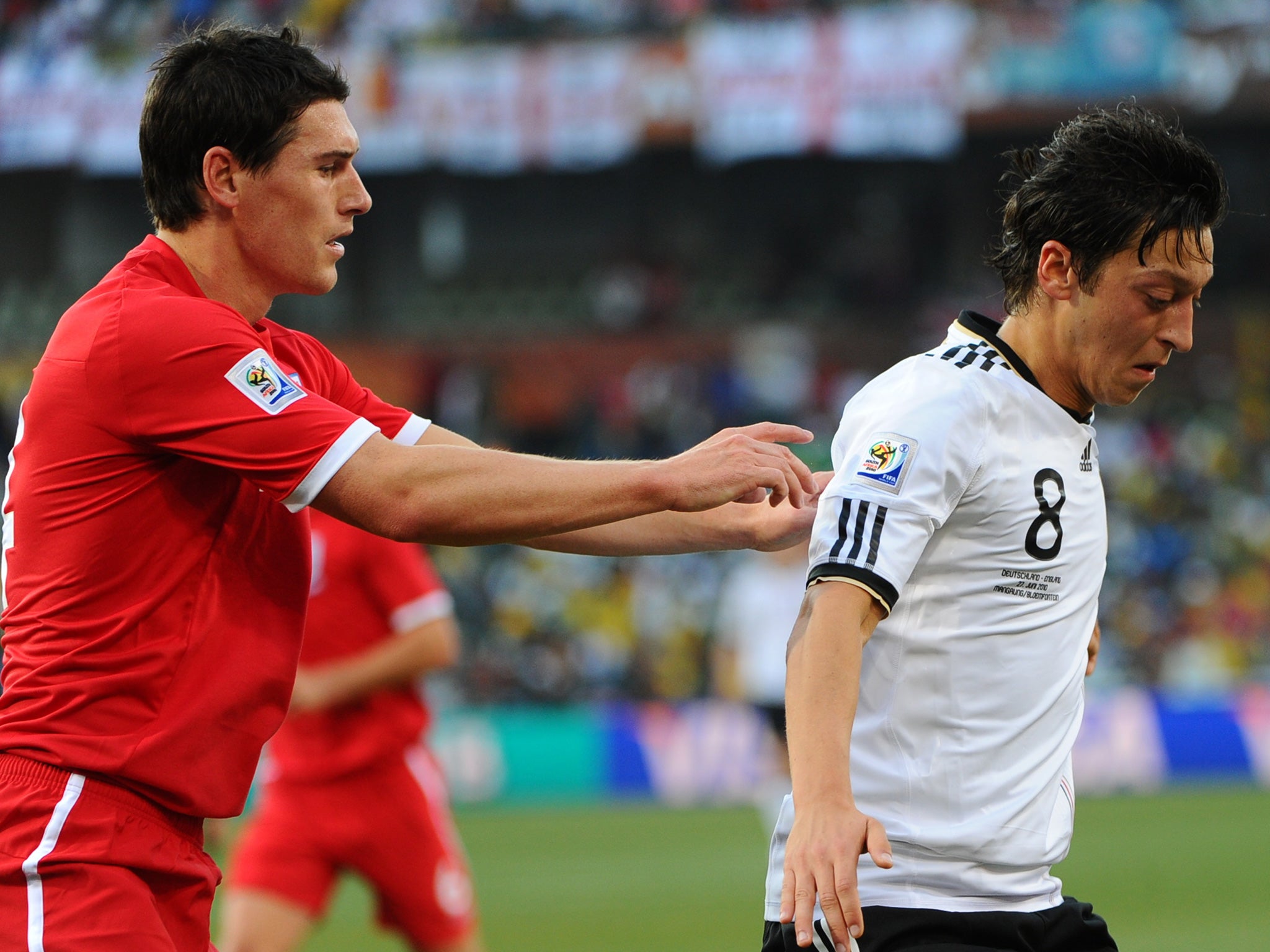 Barry challenges Mesut Ozil during England's 4-1 defeat to Germany at the 2010 World Cup