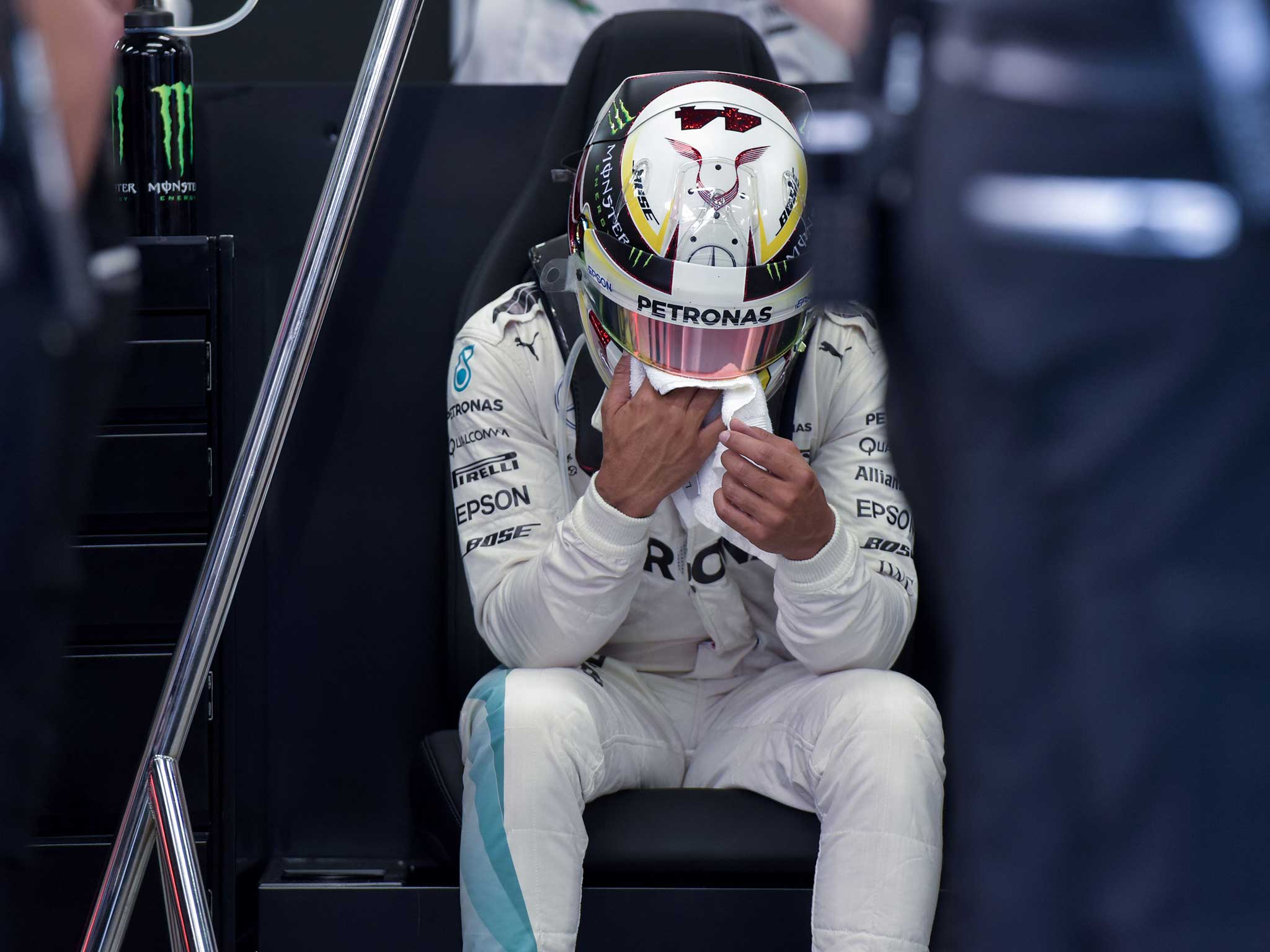 Lewis Hamilton takes a moment to himself after a disappointing day