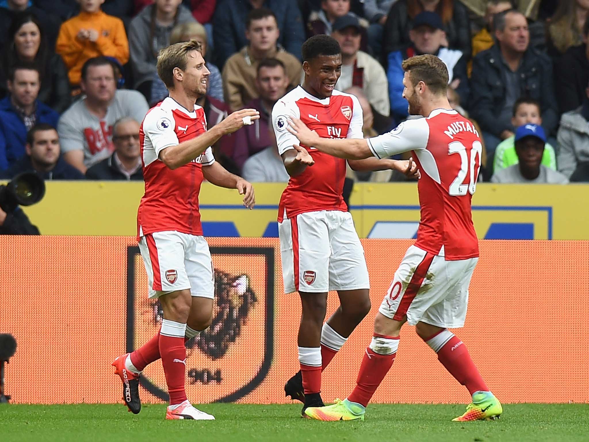 Alex Iwobi celebrates putting Arsenal ahead at Hull - although replays revealed Alexis Sanchez got the last touch