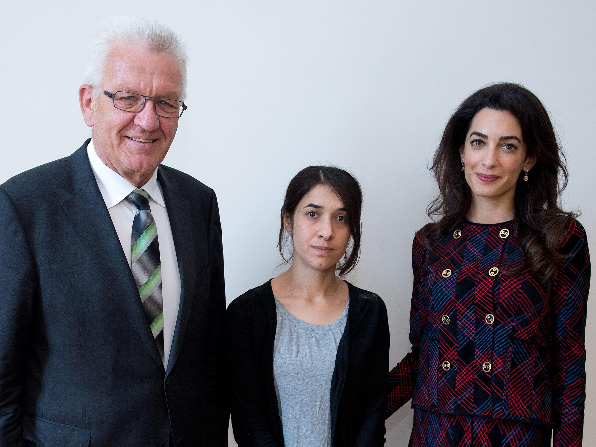 Premier of federal state Baden-Wuerttemberg Winfried Kretschmann (L) meets with Yezidi woman Nadia Murad (C) and British human rights attorney Amal Clooney (R) at the state ministry in Stuttgart, Germany, 12 September 2016. Amal Clooney is campaigning for international awareness of the Yezidi people's situation in the northern Iraq.