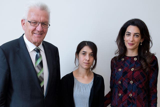 Premier of federal state Baden-Wuerttemberg Winfried Kretschmann (L) meets with Yezidi woman Nadia Murad (C) and British human rights attorney Amal Clooney (R) at the state ministry in Stuttgart, Germany, 12 September 2016. Amal Clooney is campaigning for international awareness of the Yezidi people's situation in the northern Iraq.