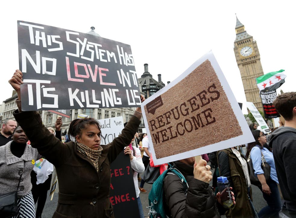 People march through central London as they take part in a protest rally organised by Solidarity with Refugees in a bid to urge the Government to take more action on the migrant crisis
