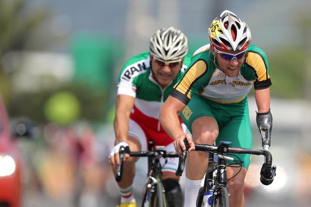 Iranian cyclist Bahman Golbarnezhad (L) behind South Africa's Dane Wilson (R) in the men's road race C4-5