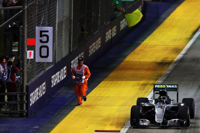 Nico Rosberg narrowly avoids hitting a marshal during the Singapore Grand Prix