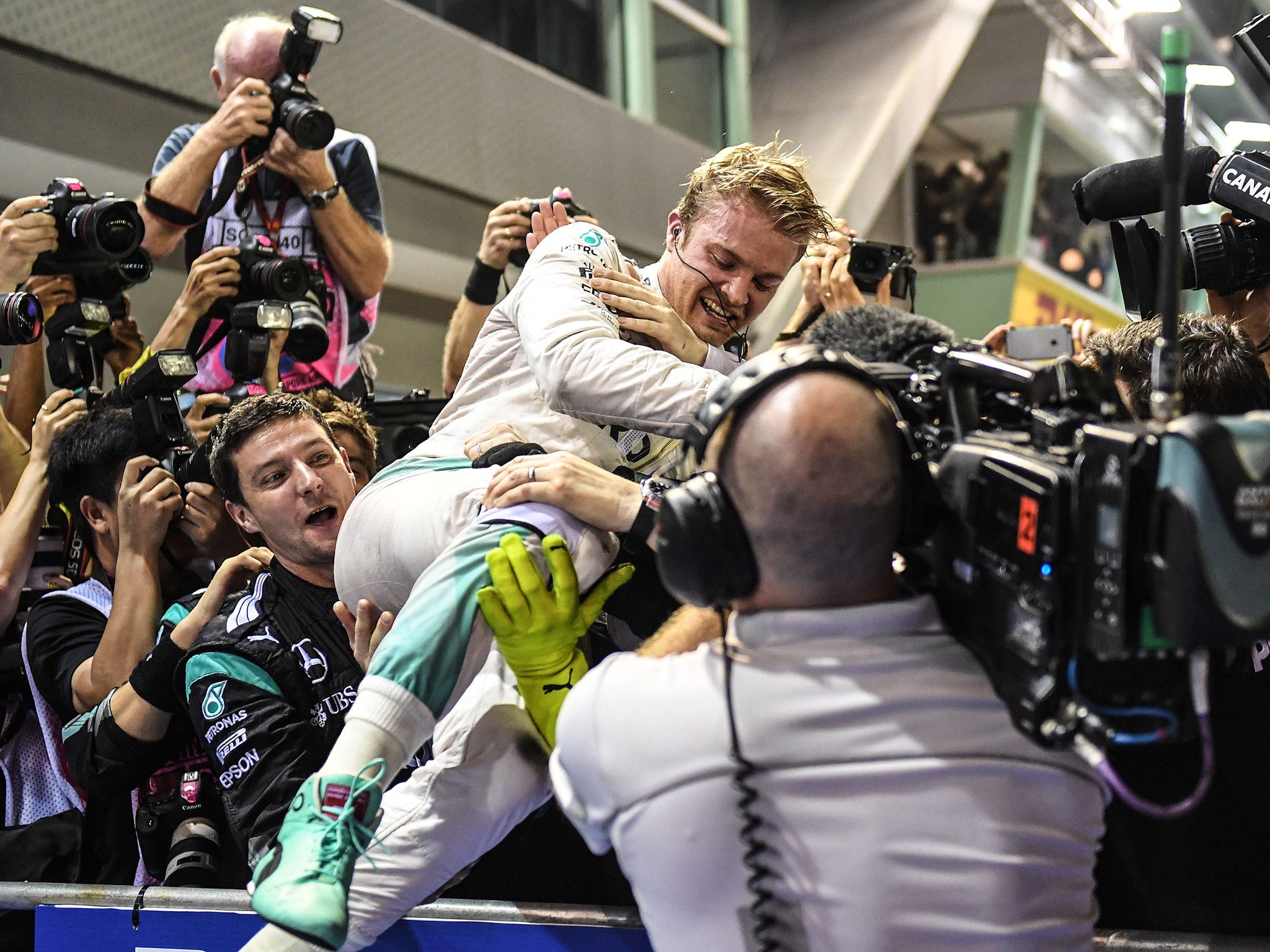 Rosberg celebrates with his team after the race