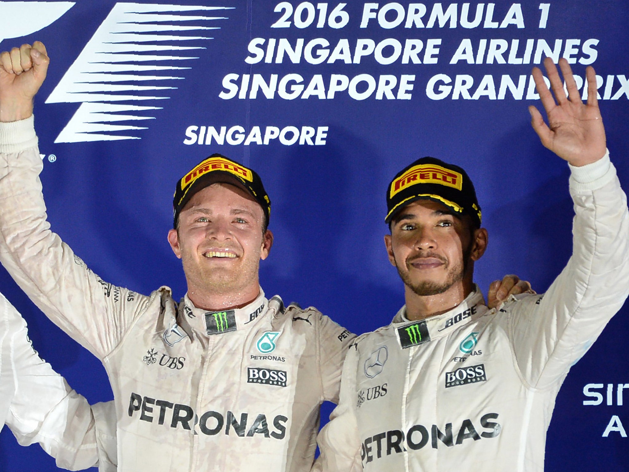 Nico Rosberg and Lewis Hamilton wave to the crowd on the podium in Singapore