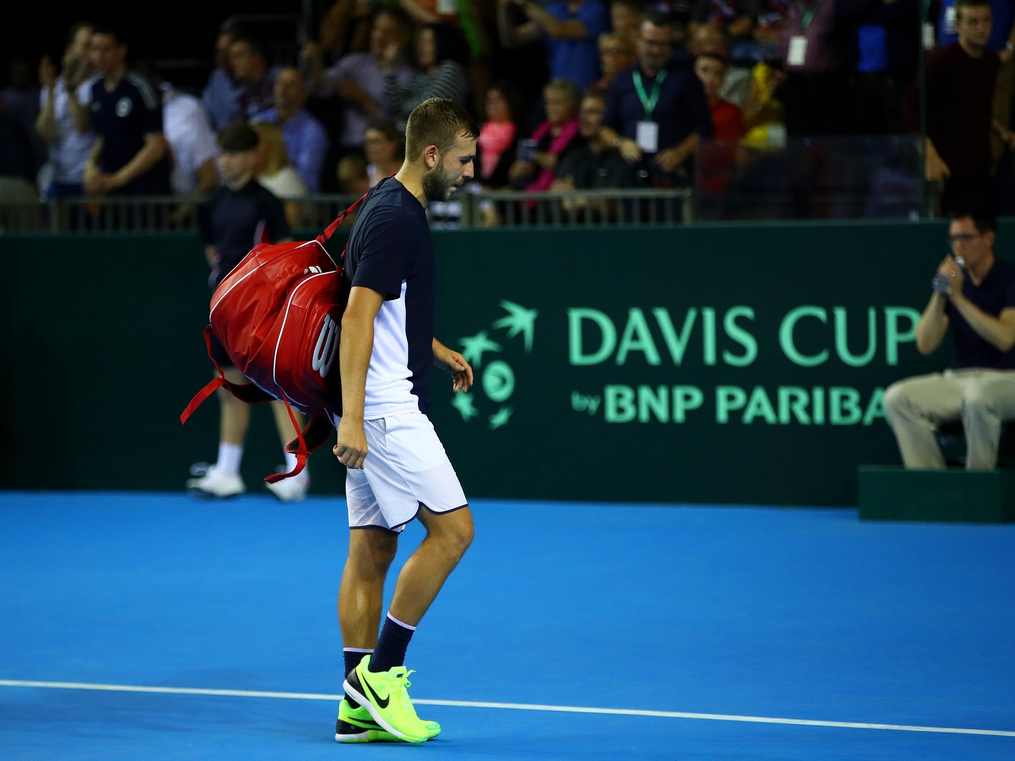 Dan Evans leaves the court after a narrow defeat