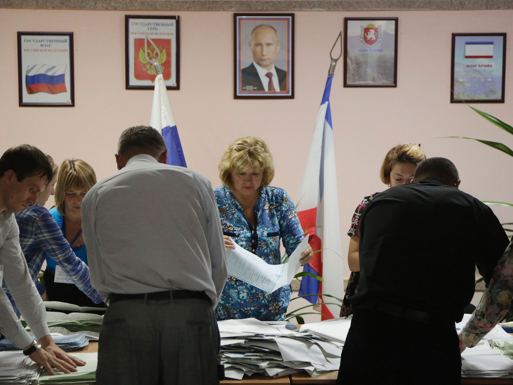 Members of the election commission counting ballots at a polling station in Simferopol, Crimea