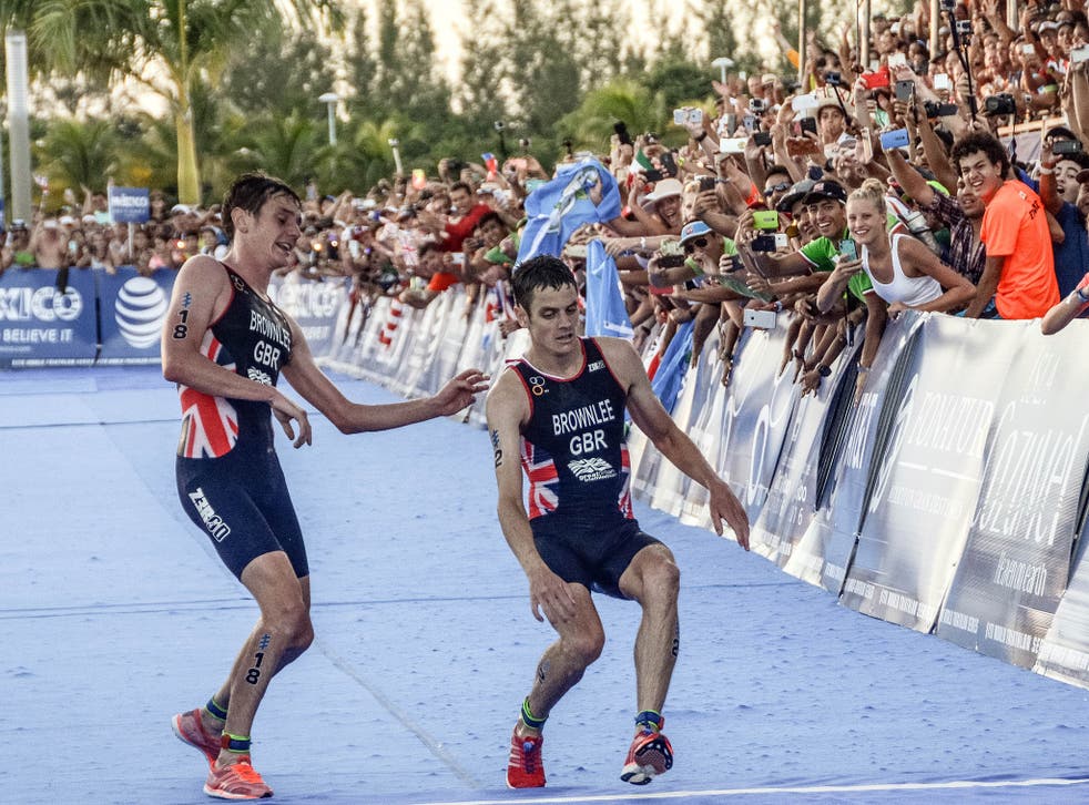 Jonny Brownlee collapses as he reaches the finish line alongside brother Alistair
