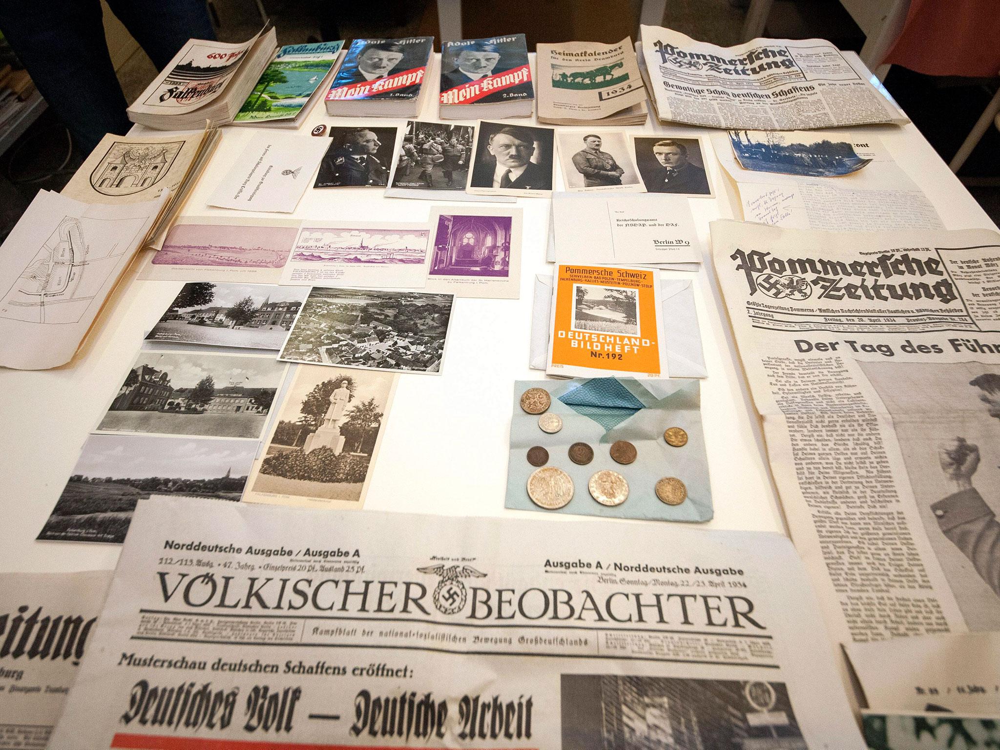 Photographs, newspapers, documents, copies of the book 'Mein Kampf' and coins from a time capsule are presented at the National Museum in Szczecin