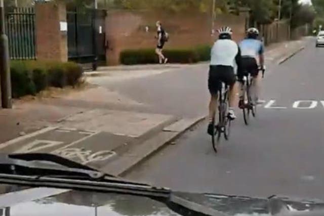 Video shows cyclists riding in the road adjacent to an empty bike lane