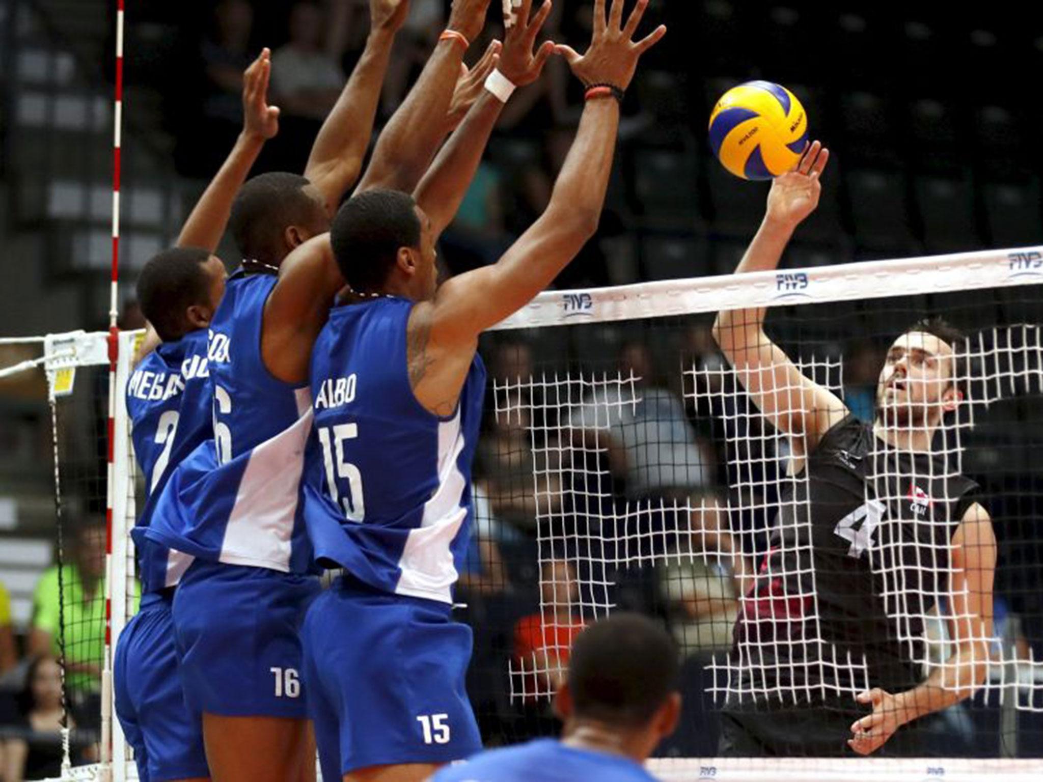 File photo taken on shows (L-R) Abrahan Alfonso Gavilan, Luis Tomas Sosa Sierra and Dariel Albo Miranda of Cuba defending against the Canadian team during a match at the 2016 Volleyball World League in Tampere, Finland.
