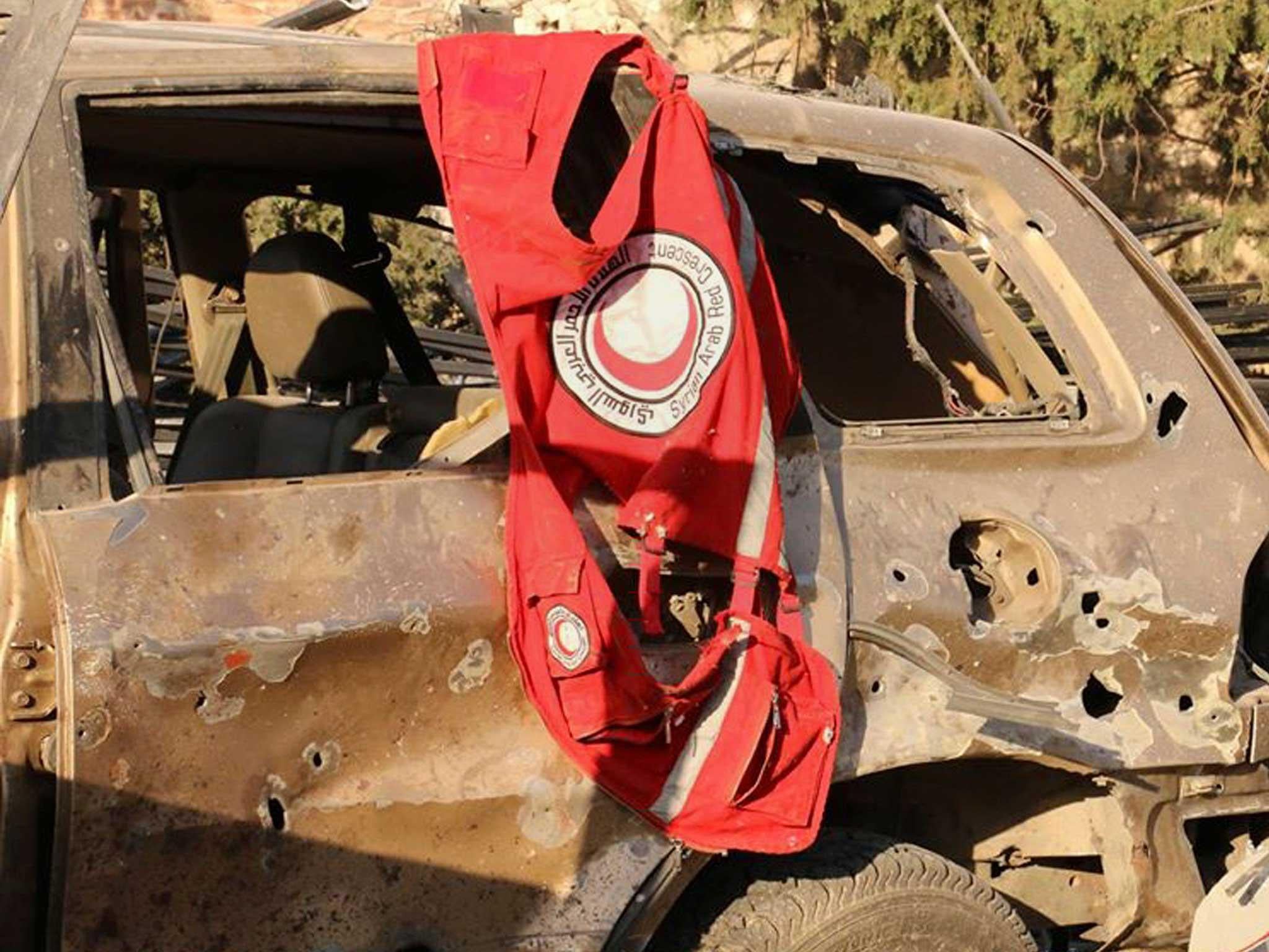 A vest of the Syrian Arab Red Crescent hanging on a damaged vehicle, in Aleppo