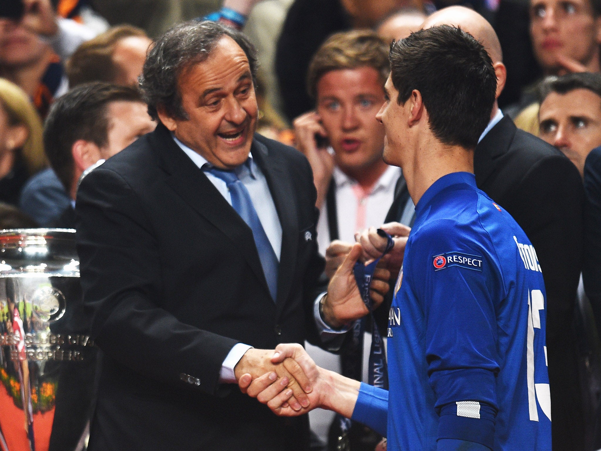 Thibaut Courtois shakes hands with Real Madrid president Florentino Perez