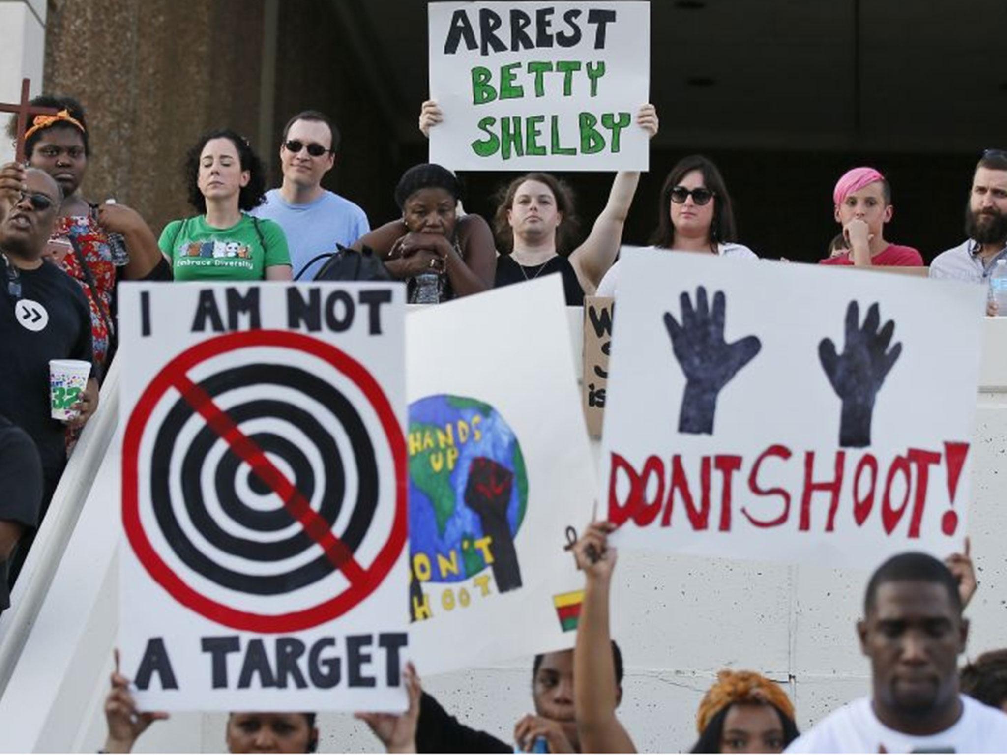 People hold signs at a 'protest for justice' over the shooting of Terence Crutcher, sponsored by We the People Oklahoma, in Tulsa, Oklahoma, 20 September, 2016