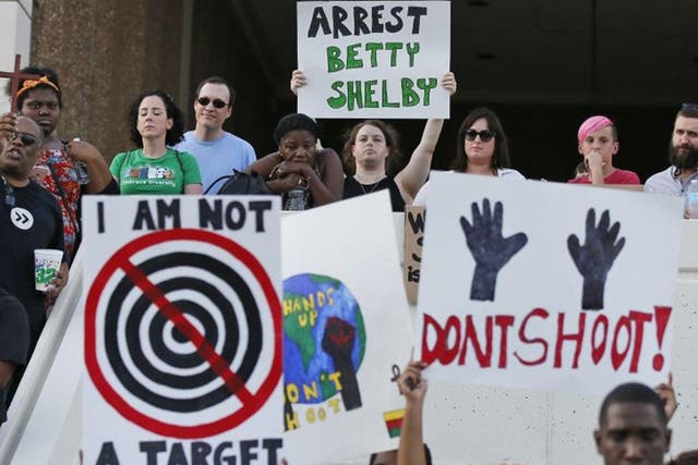 People hold signs at a 'protest for justice' over the shooting of Terence Crutcher, sponsored by We the People Oklahoma, in Tulsa, Oklahoma, 20 September, 2016