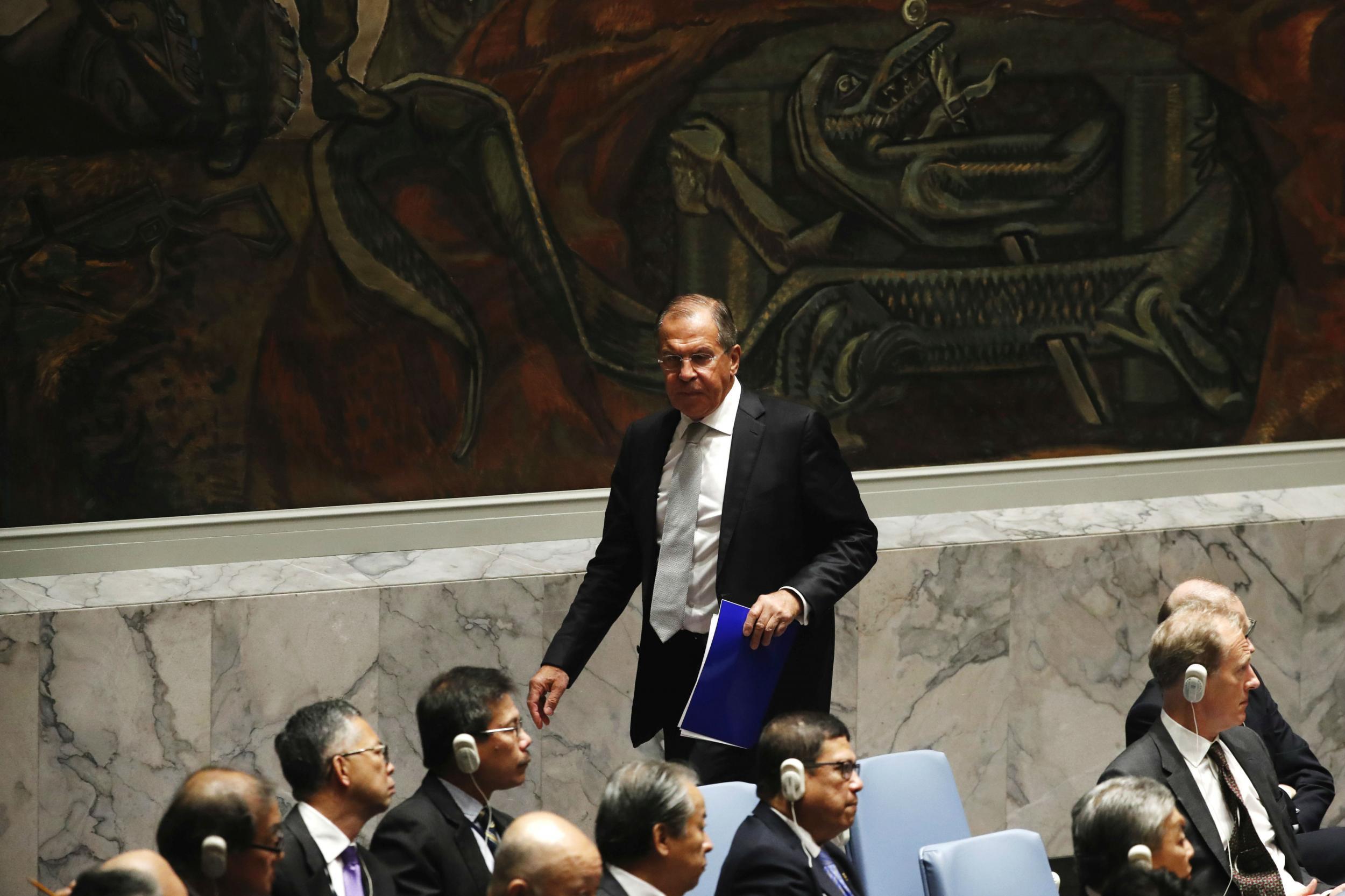 &#13;
Sergey Lavrov leaves the chamber after listening to John Kerry’s comments &#13;