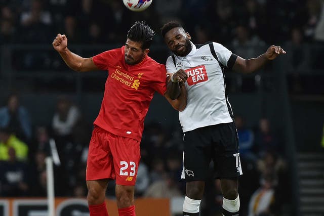 Emre Can jumps for the ball with Darren Bent at Derby County