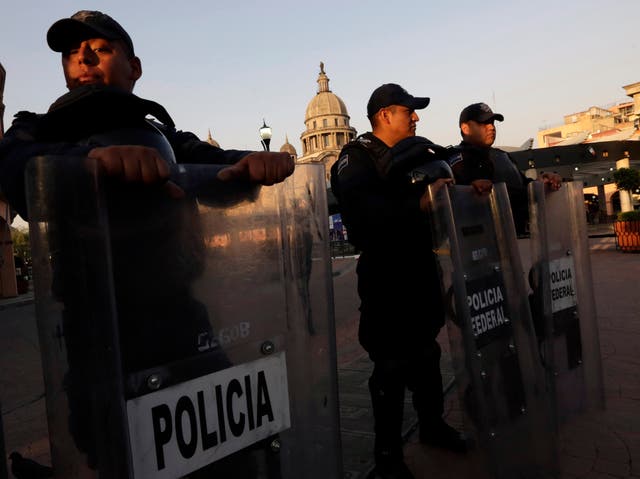 Mexican federal police stand guard outside the San Jose Cathedral in Toluca near Mexico City