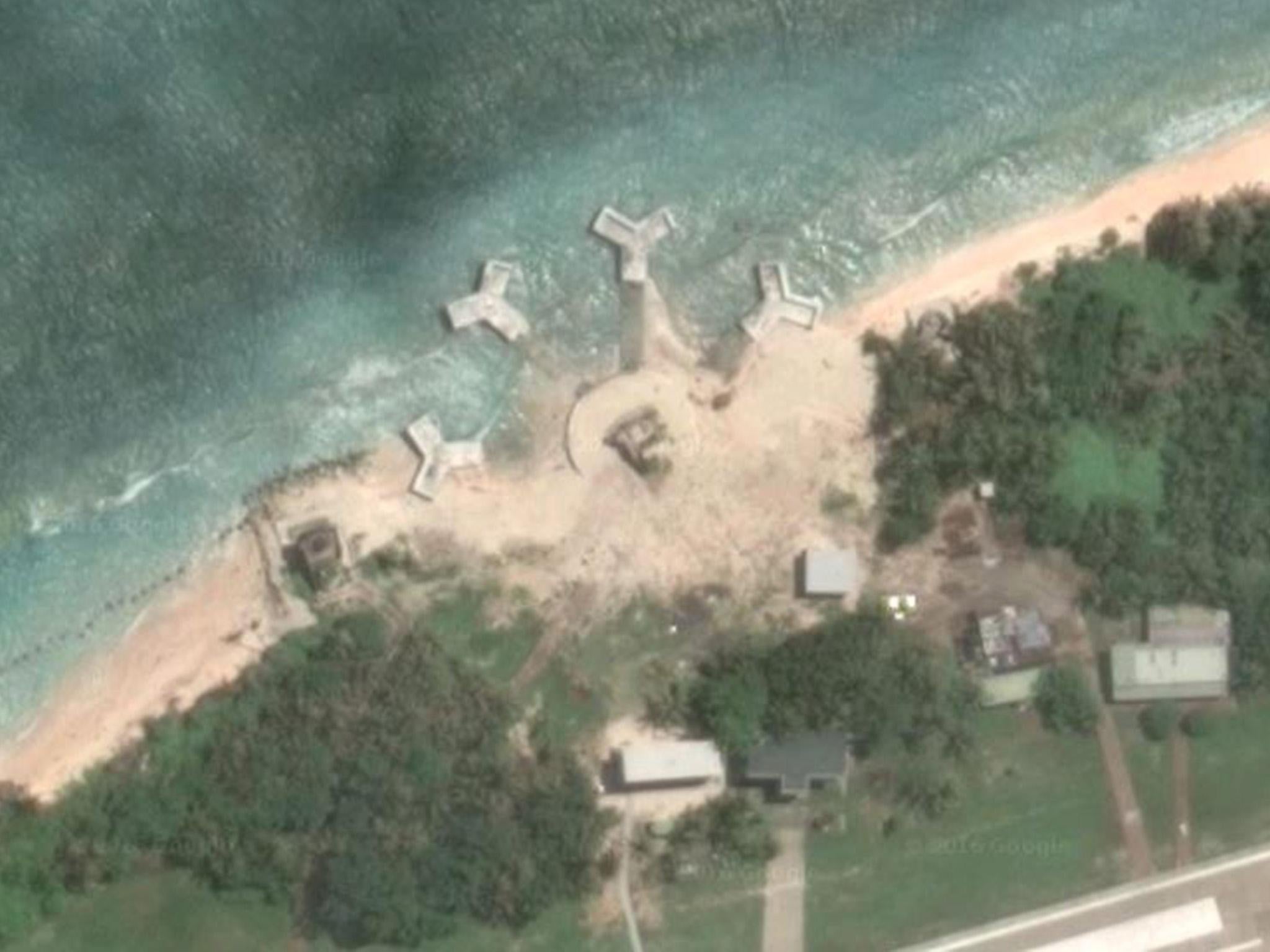 Satellite images show buildings built on one of the disputed Spratly islands