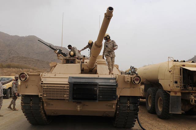 Saudi troops pictured atop their tank on the Saudi Arabian-Yemeni border <em>Fayez Nureldine/AFP/Getty </em>