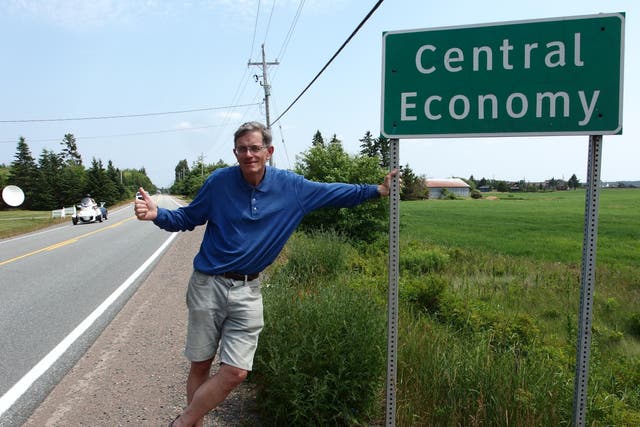Serial hitcher Simon Calder thumbing a ride in Central Economy, Nova Scotia, Canada