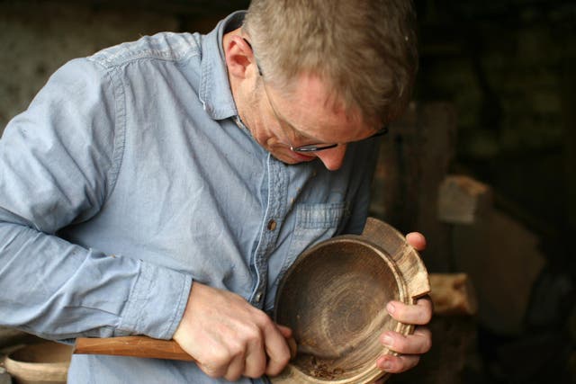 Robin Wood has revived the once-lost craft of woodturning on a pole lathe, here he puts the final touches on a porringer bowl