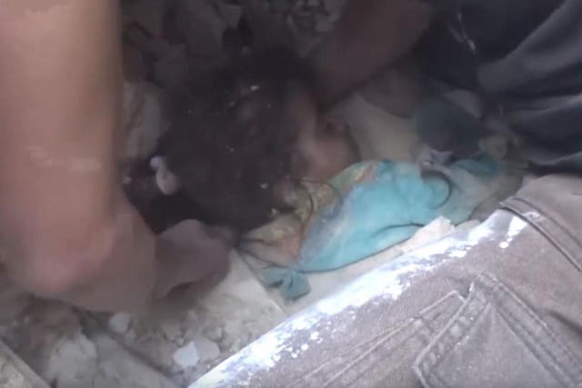 Rescue workers digging a young girl out of rubble following air strikes on rebel-held parts of Aleppo, Syria, on 23 September