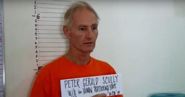 Peter Scully (right) leaves court handcuffed to another inmate on the southern Philippine island of Mindanao in June last year