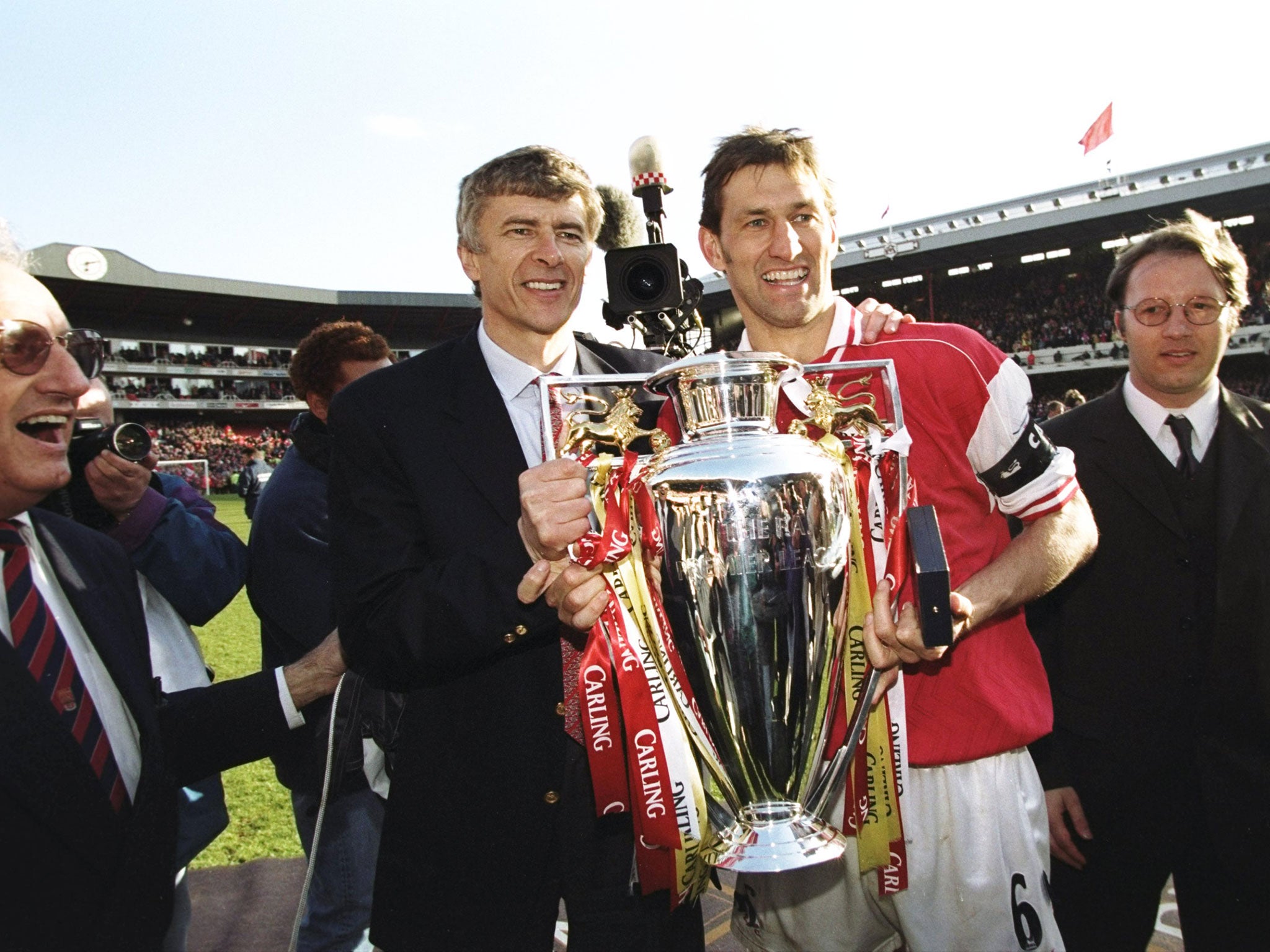 The glory days: Wenger and club captain Tony Adams hold the championship trophy after the FA Carling Premiership match against Everton at Highbury. Arsenal won 4-0 to secure the title.