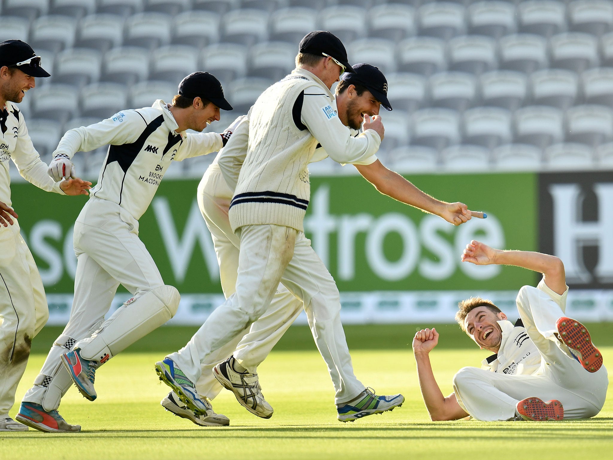 The Middlesex team rush to congratulate Toby Roland-Jones moments after he won the title for his side