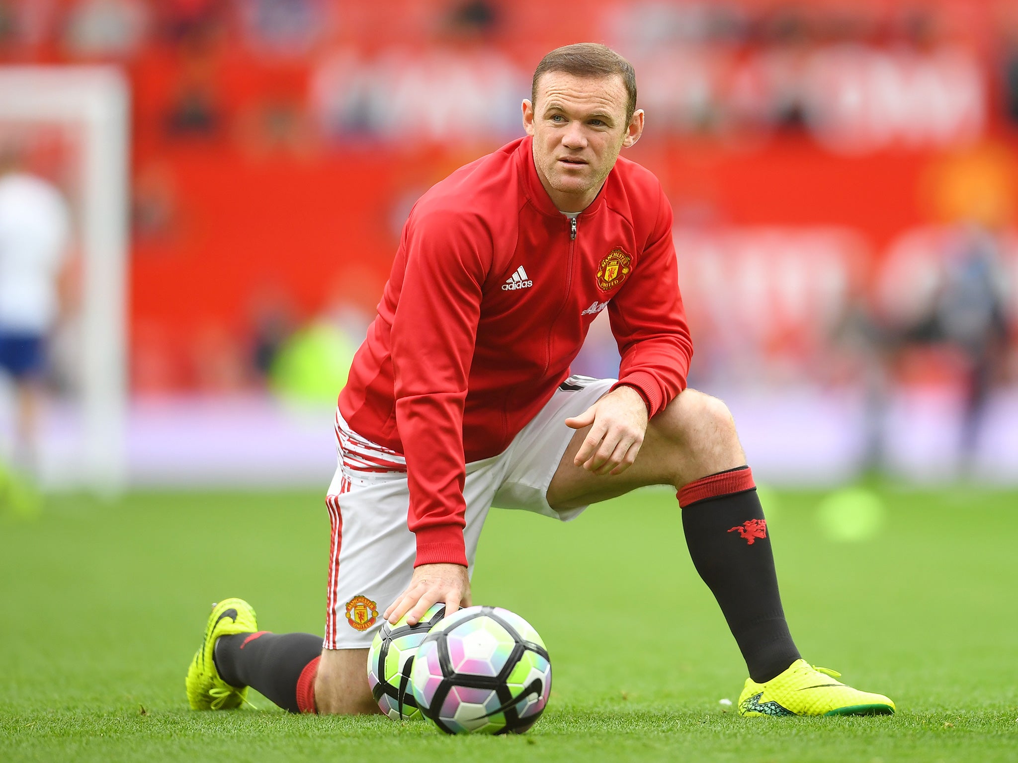 Rooney watches his team-mates warm up