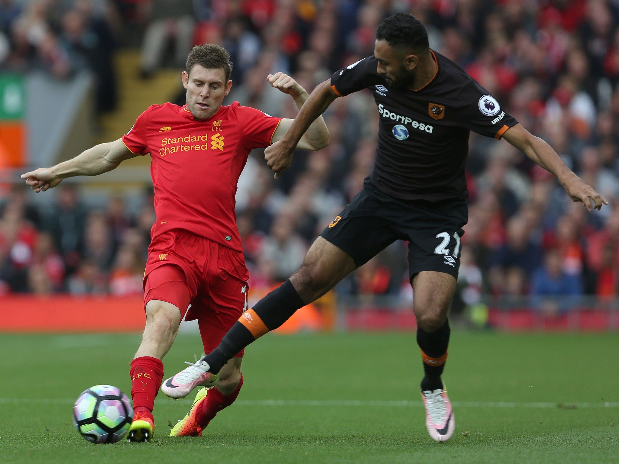 Milner and Elmohamady battle for the ball at Anfield