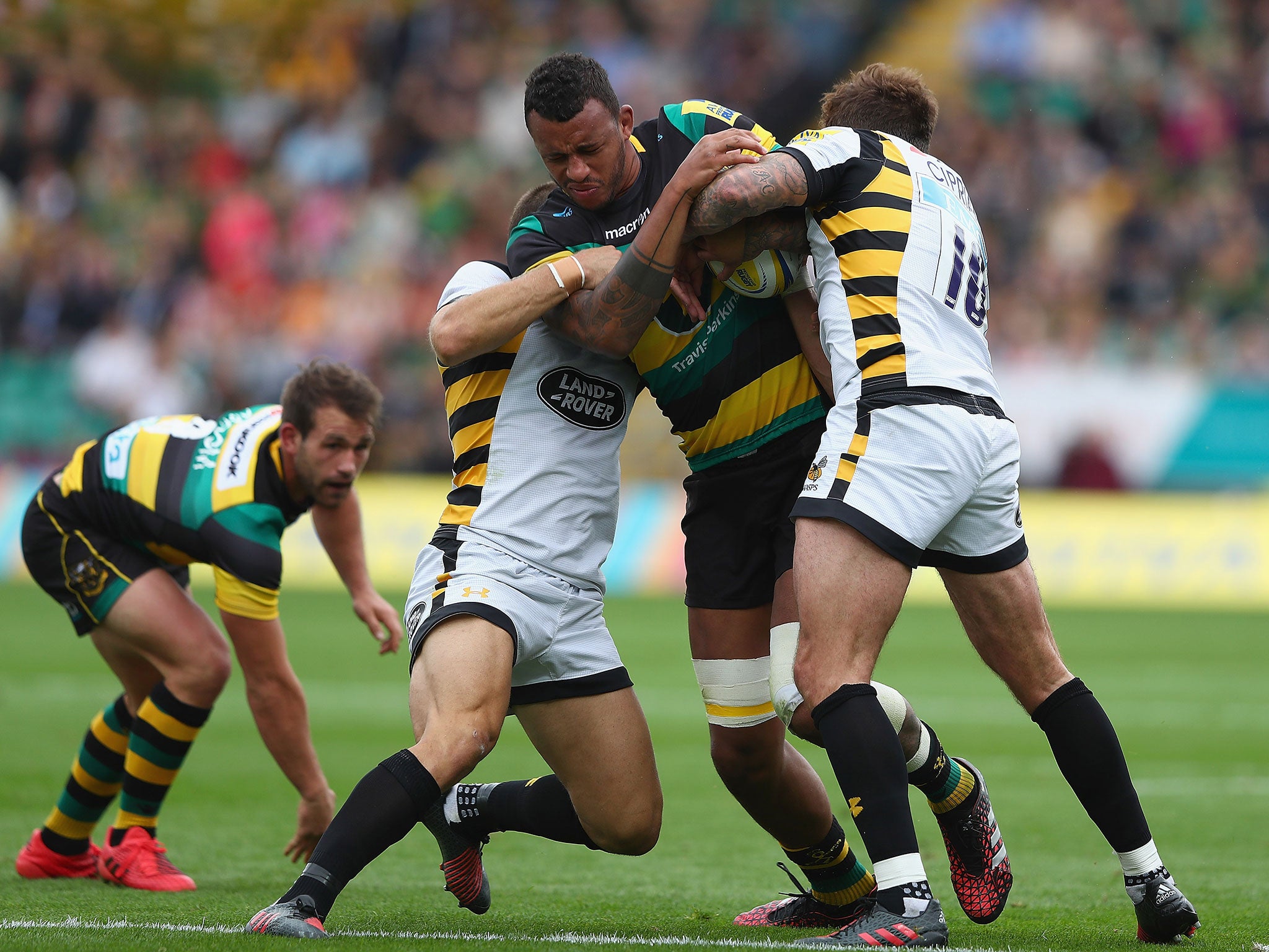 Courtney Lawes is bundled by the Wasps defence