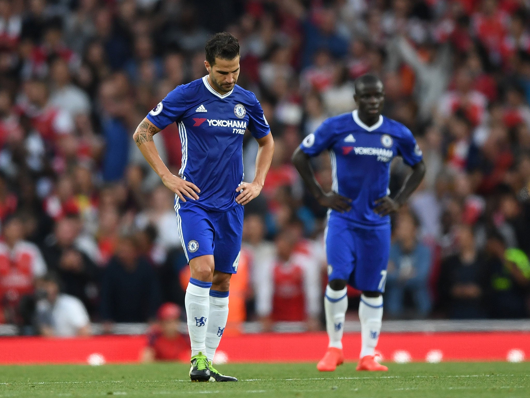 Cesc Fabregas cuts a dejected figure during his side's 3-0 defeat by Arsenal