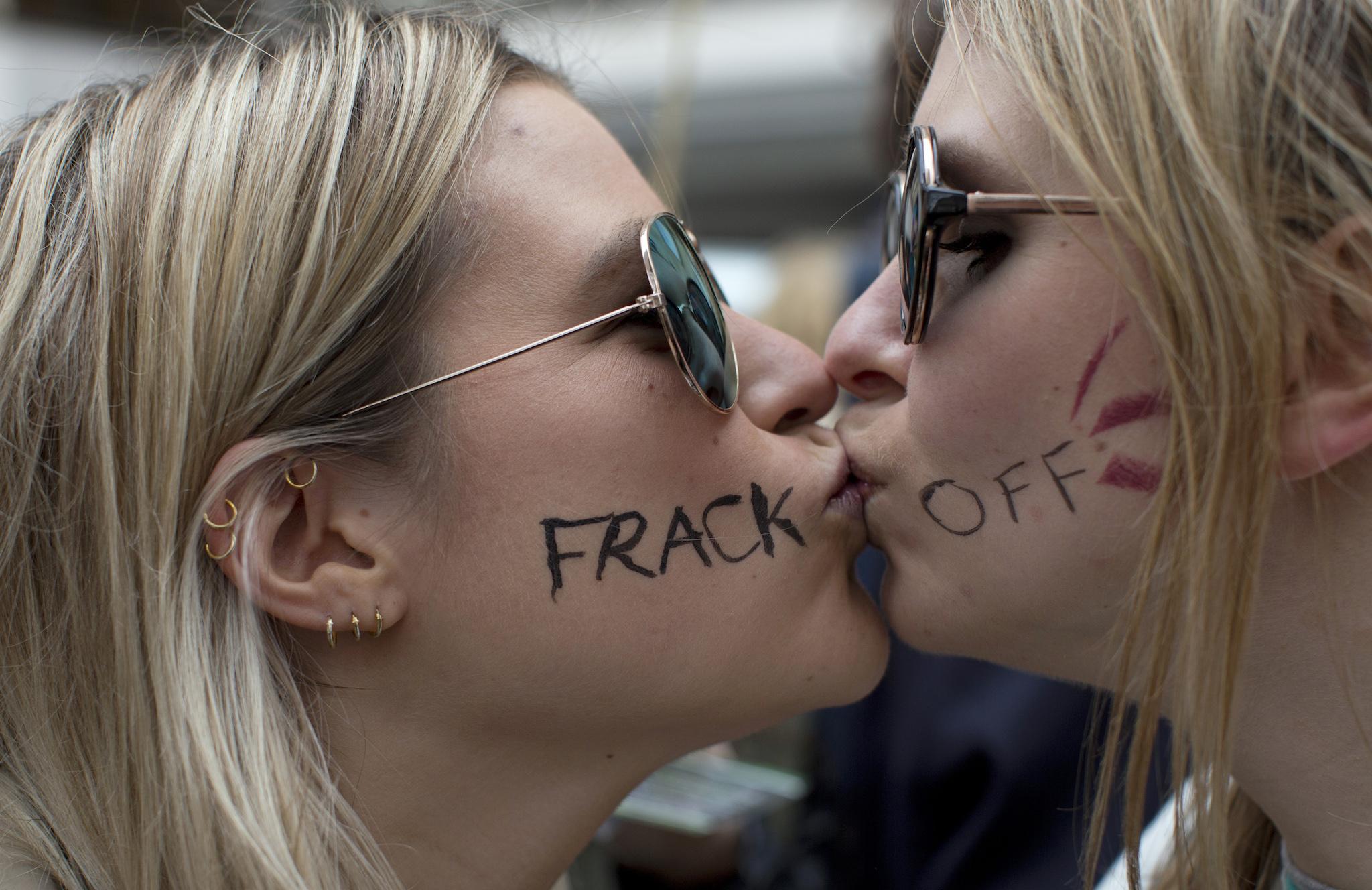 Two demonstrators kiss as they pose for a photograph during an anti-fracking protest in central London March 19, 2014