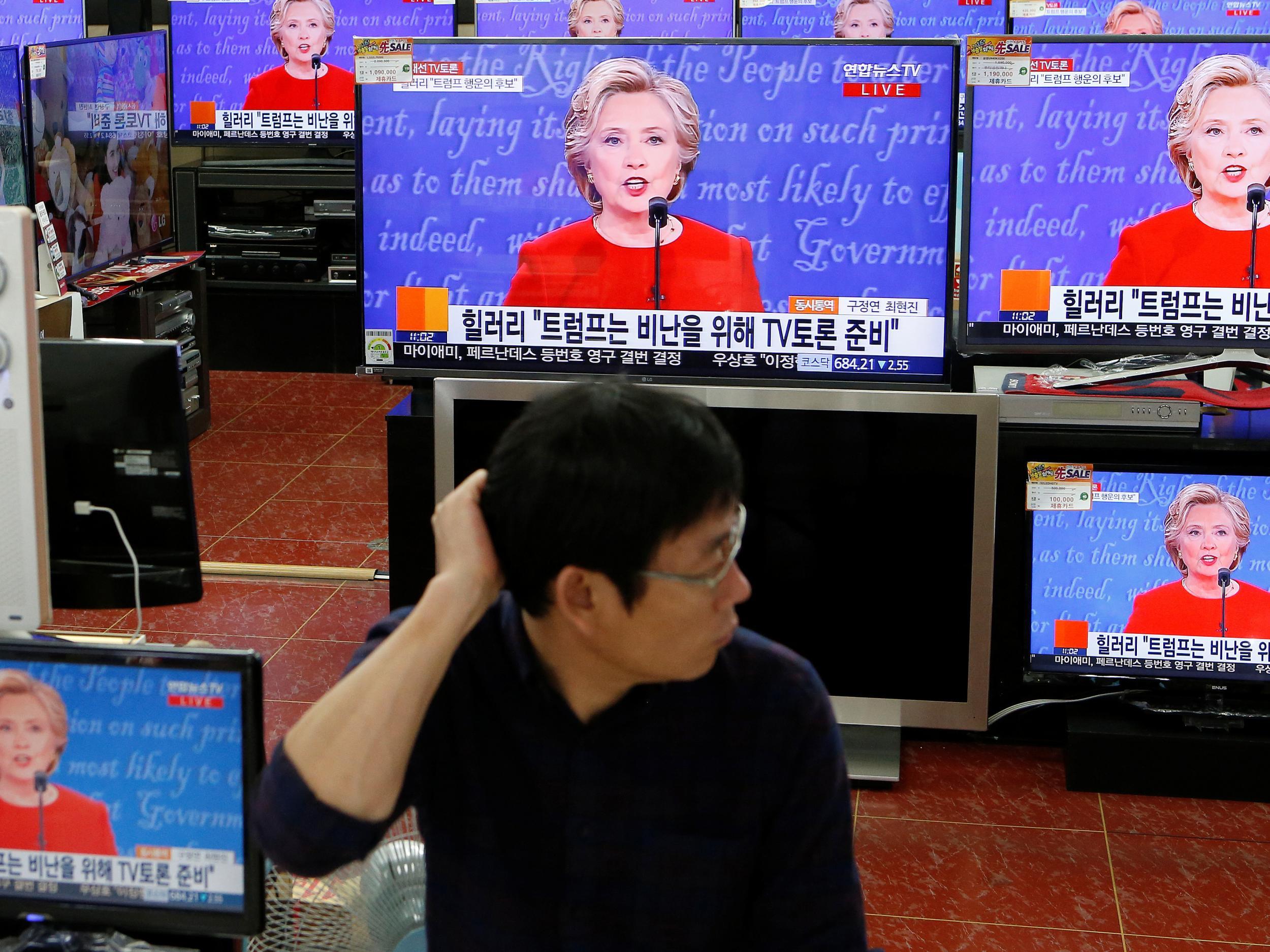A man watches the US presidential debate in a shop in Korea. The country's Kospi index surged as Hillary Clinton was seen to triumph