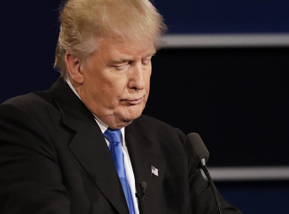 Donald Trump listens to an answer to a question from Hillary Clinton