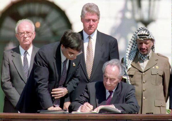 Shimon Peres signs the Oslo Peace Accords in Washington DC in 1993