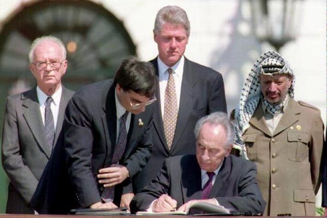 Shimon Peres signs the Oslo Peace Accords in Washington DC in 1993 
